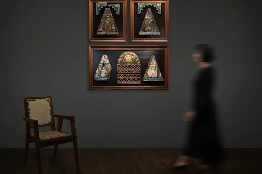 a visual image of a wall artpeice accompanied by an antique chair to create contrast.