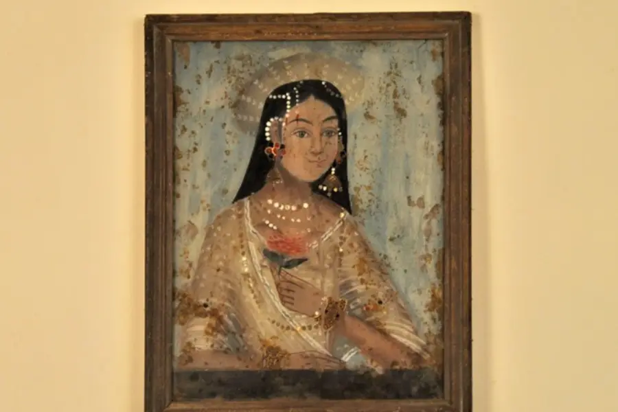 Vintage Indian portrait painting in a rustic wooden frame displayed as heritage wall art at Circa Warehouse.